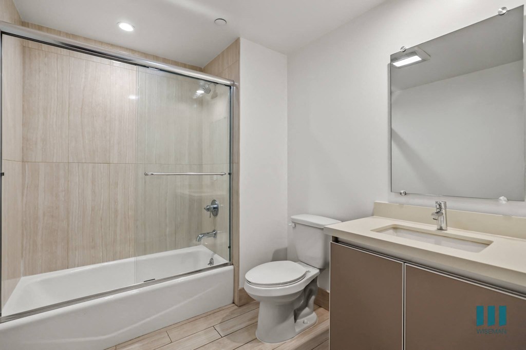 Bathroom with Shower Bath with Glass Door and Vanity Cabinet Storage