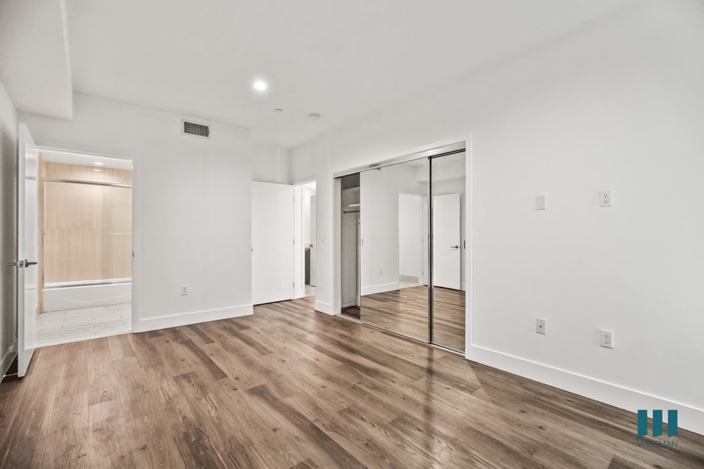Bedroom with Mirrored Closet, Bathroom, Vinyl Flooring, and Recessed Lighting