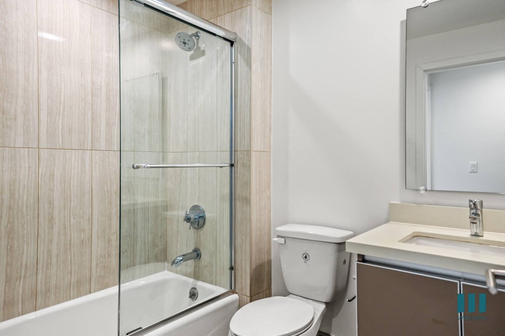 Bathroom with Shower Bath with Glass Door and Vanity Cabinet Storage
