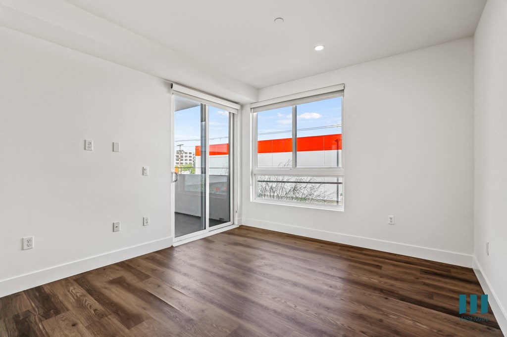 Bedroom with Large-Size Windows, Vinyl Flooring, and Patio