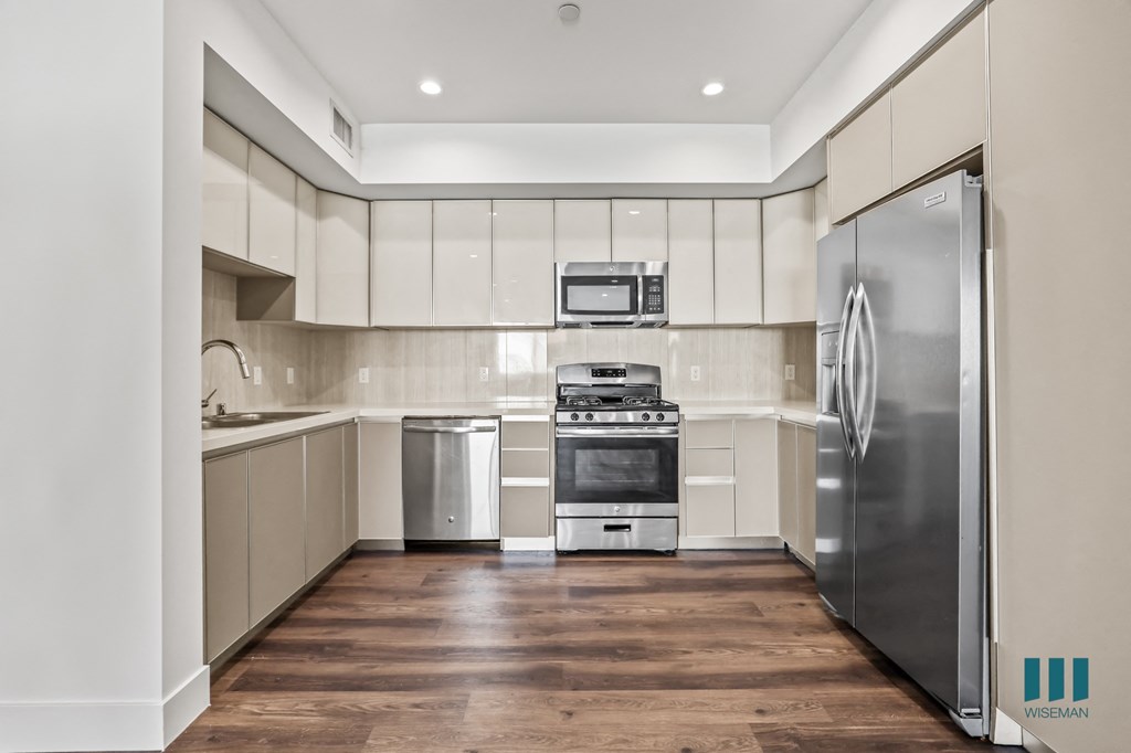 Full-Size Kitchen with Stainless-Steel Refrigerator, Stove, Microwave Oven, and Dishwasher