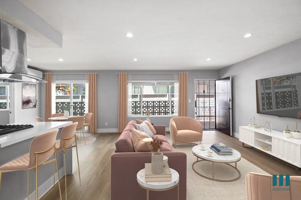 a living room with a couch and chairs and a kitchen