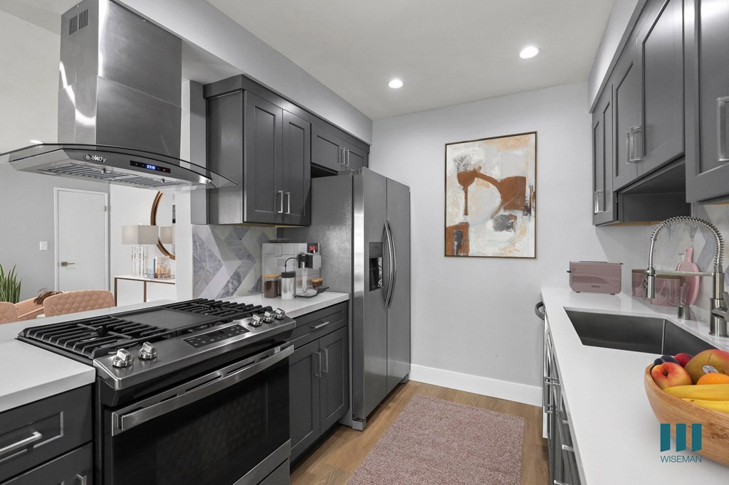 a kitchen with stainless steel appliances and black cabinets
