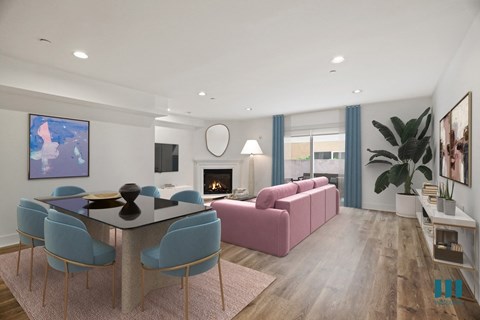 a living room with a pink couch and a table and chairs