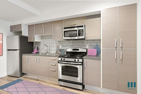 a kitchen with stainless steel appliances and wooden cabinets