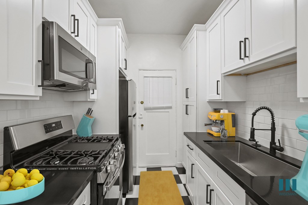 Kitchen with Stainless-Steel Refrigerator, Stove, Microwave Oven, and Dishwasher Kitchen with Stainless-Steel Refrigerator, Stove, Microwave Oven, and Dishwasher