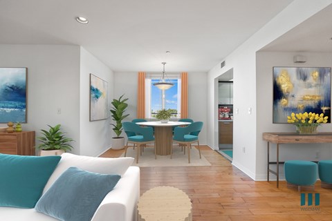 A living room with a white couch and a dining table.