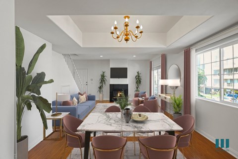 a living room with a marble table and chairs and a fireplace