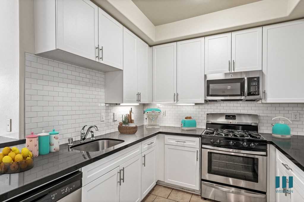 Kitchen with Stainless-Steel Dishwasher, Stove, and Microwave Oven