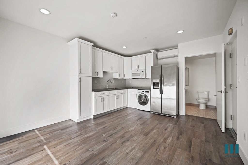 A kitchen with white cabinets and stainless steel appliances.