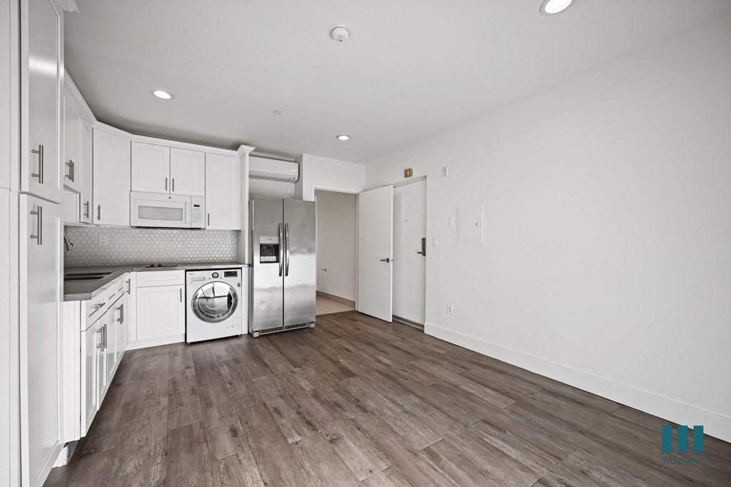 A kitchen with white cabinets and stainless steel appliances.
