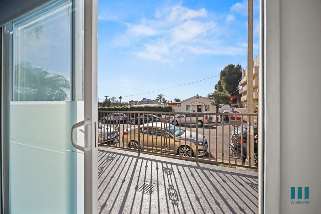 A view from a room looking out to a parking lot.