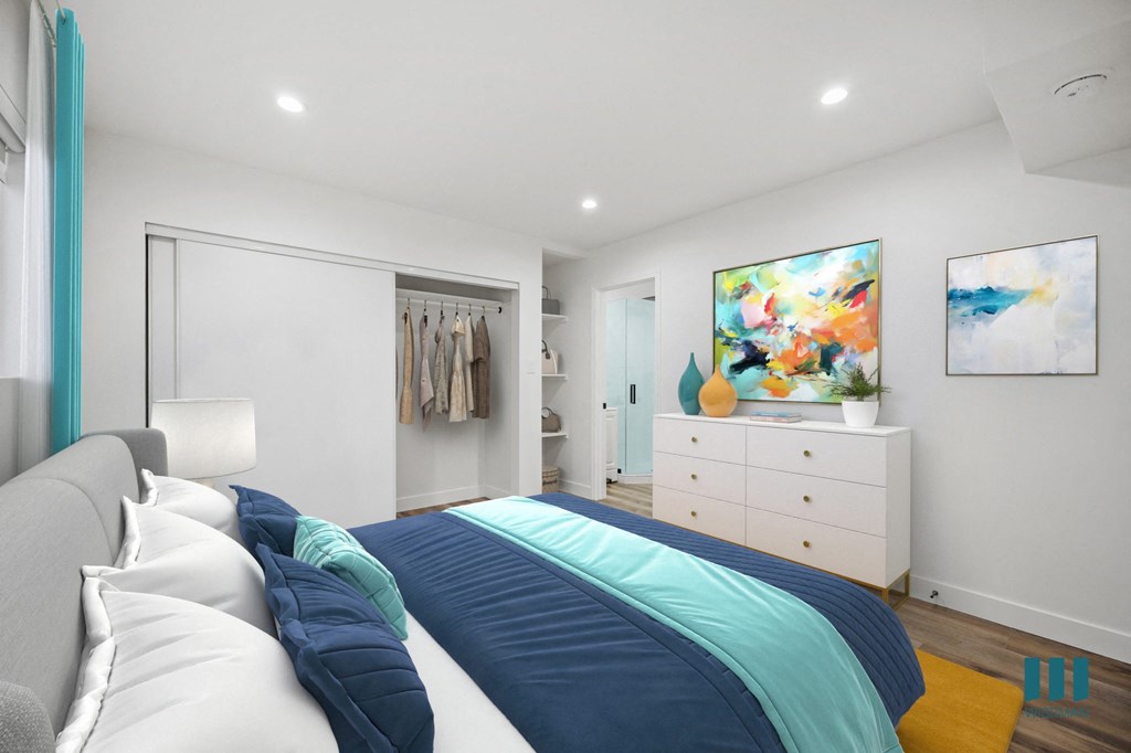 A bedroom with a large bed and a painting on the wall.