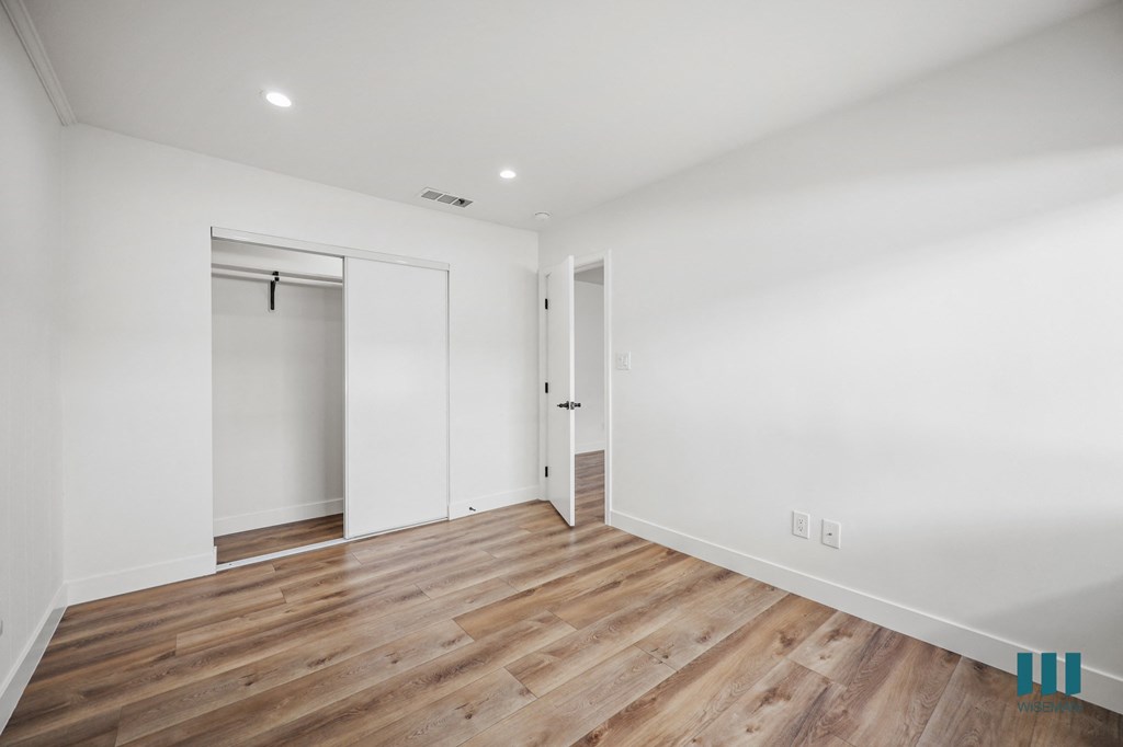 A room with wooden floors and white walls.