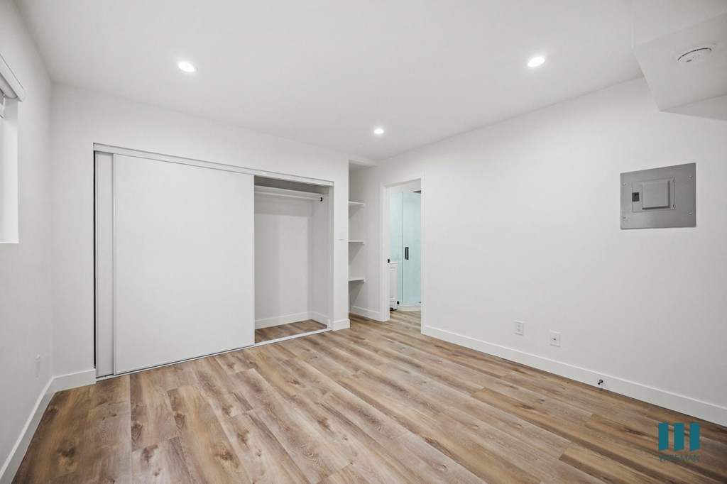 A room with a white door and a white wall.