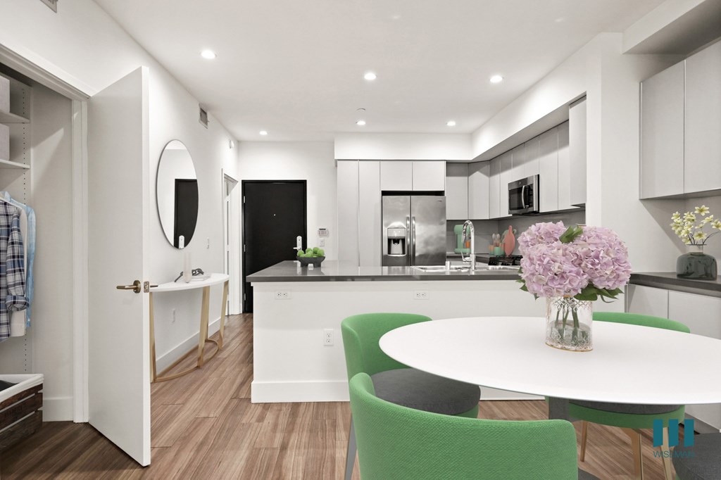 Open-Concept Kitchen and Dining Room with Hall Closet and Built-In Storage Cabinets Open-Concept Kitchen and Dining Room with Hall Closet and Built-In Storage Cabinets