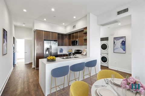 a kitchen and dining area with a table and chairs