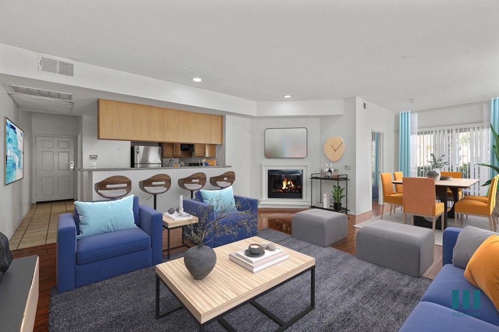 A modern living room with a fireplace and a dining area.