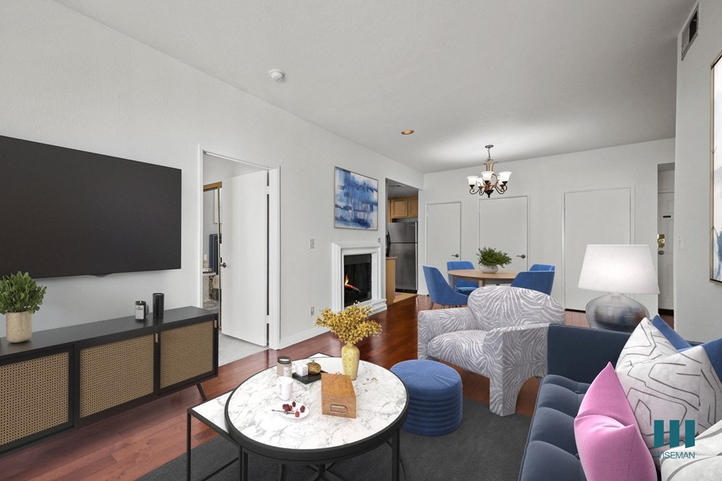 A modern living room with a fireplace and a television.