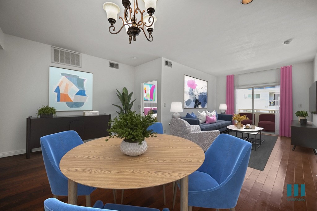 A living room with a wooden table and blue chairs.