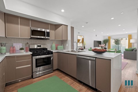 A modern kitchen with a stainless steel oven and microwave.