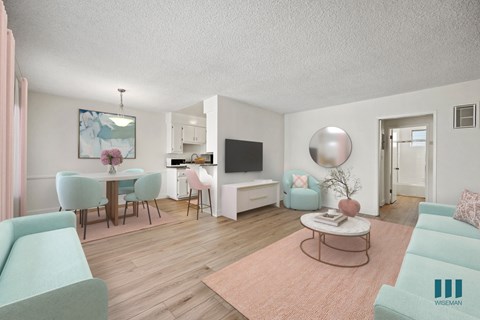 A living room with a sofa, chairs, a coffee table, and a television.