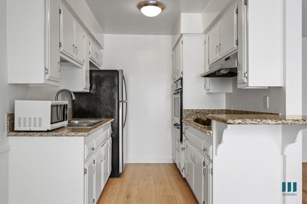 Kitchen with Stainless-Steel Refrigerator, Stovetop, and Oven