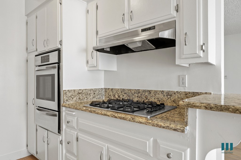Kitchen with Granite Countertops, Stainless-Steel Stove, and Ample Cabinet Storage