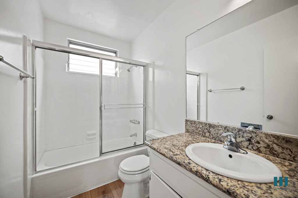 Bathroom with Shower bath with a Glass Door and Vanity Cabinet Storage