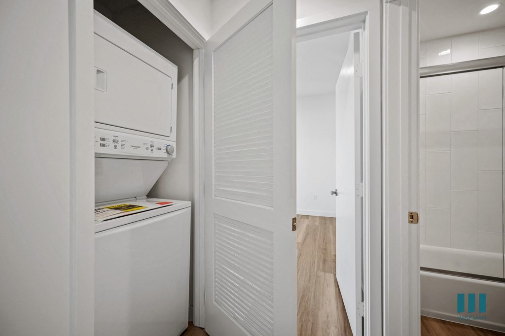 A white fridge in a kitchen with a white door.