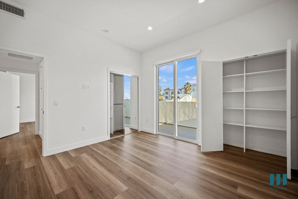 A room with wooden floors and white walls.