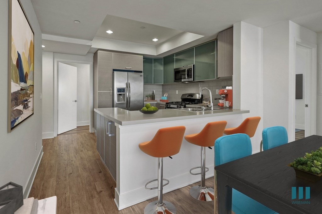 Kitchen with Countertop Bar, and Stainless-Steel Appliances