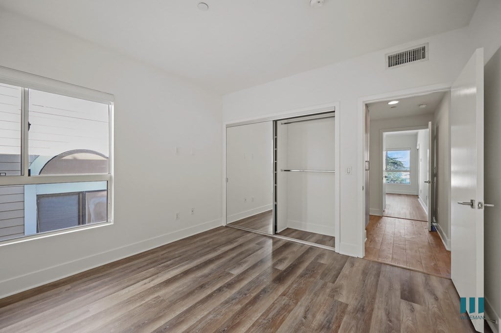 A room with wooden floors and white walls.