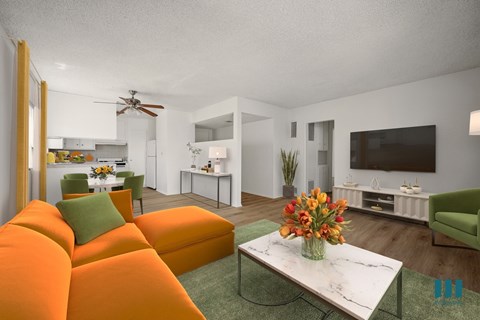 A living room with a white sofa and a green armchair.