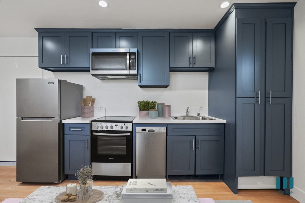 Studio Kitchen with Refrigerator, Stove, Microwave Oven, and Dishwasher