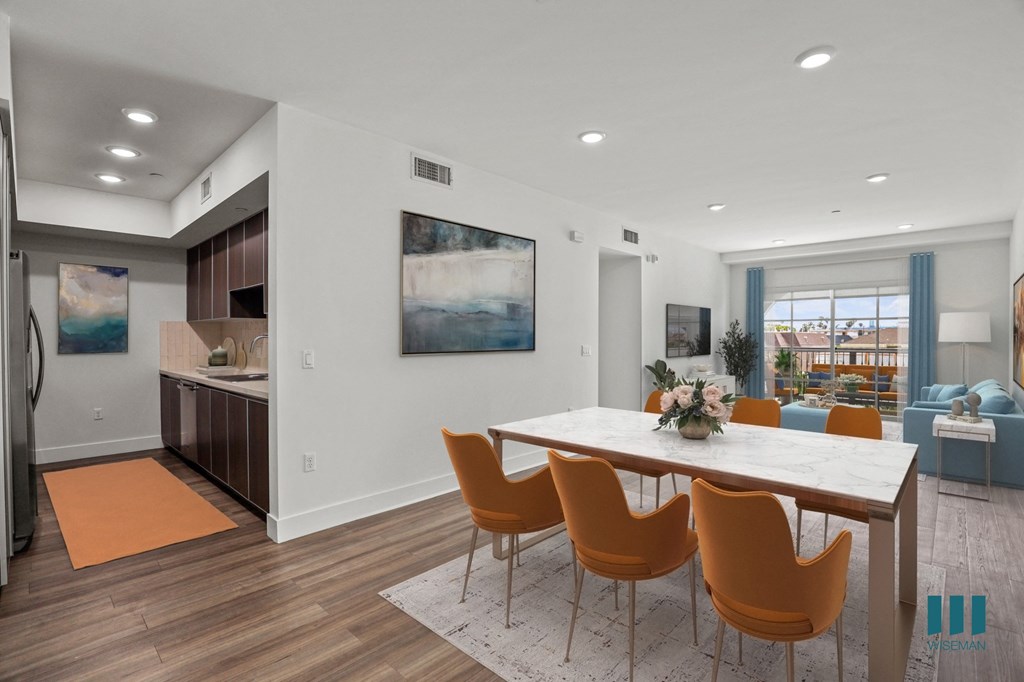 a dining room and kitchen with a table and chairs