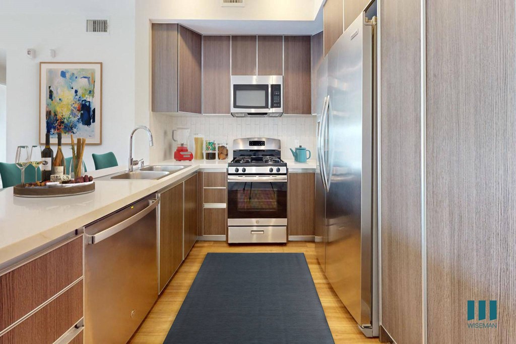 Open-Concept Kitchen with Countertop Bar and Stainless-Steel Appliances