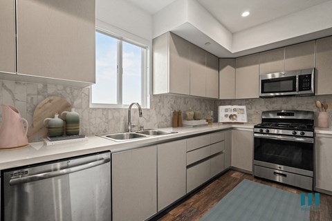 a modern kitchen with stainless steel appliances and white cabinets