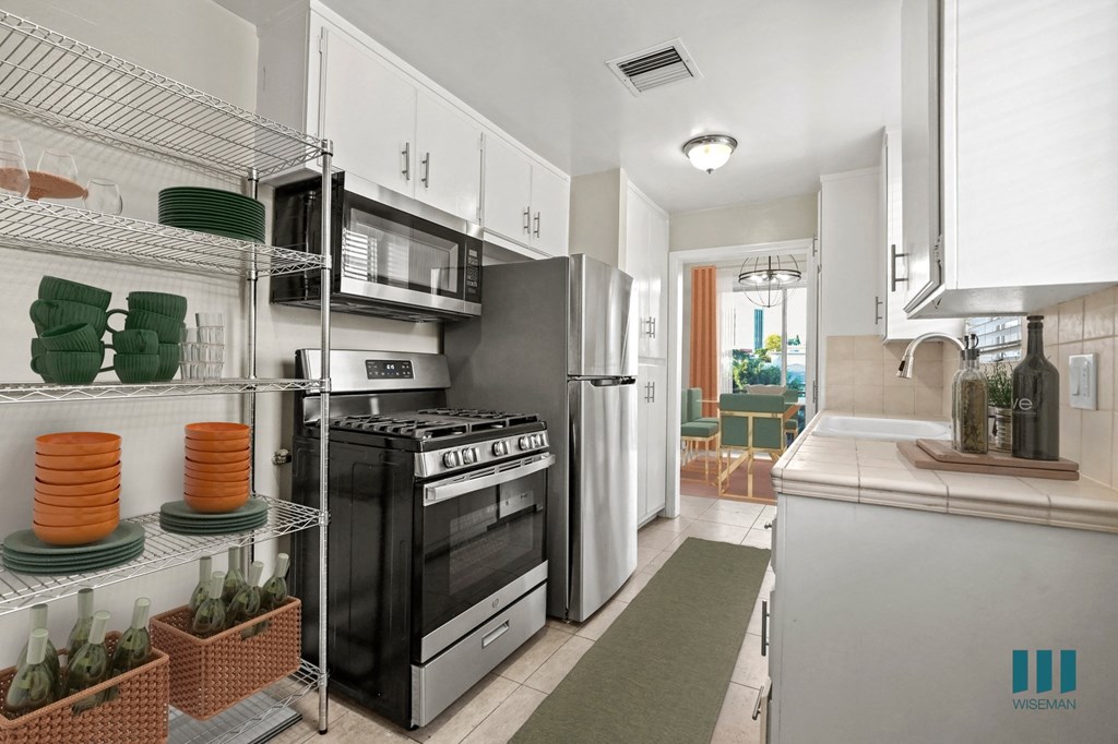 Kitchen with Stainless -Steel Refrigerator, Stove, Microwave Oven, and Dishwasher