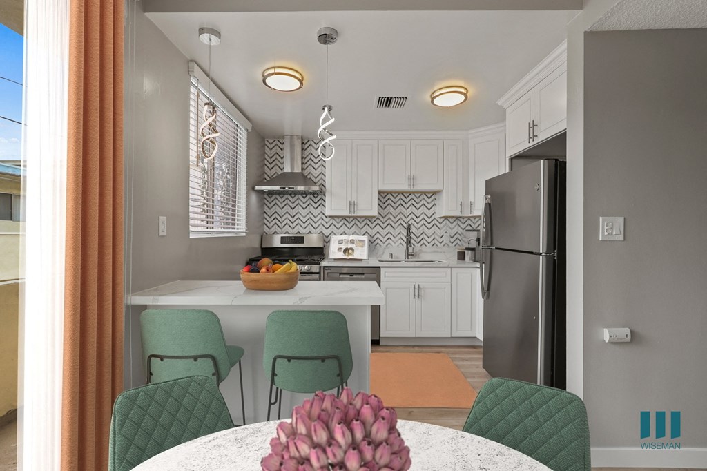 Open-Concept Kitchen with Countertop Bar and Dining Area