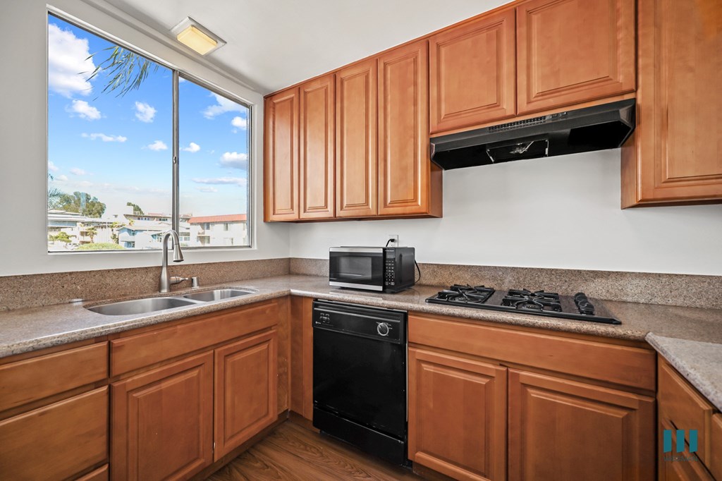 Kitchen with Gas Range, Dishwasher, microwave, and Large-Size Windows