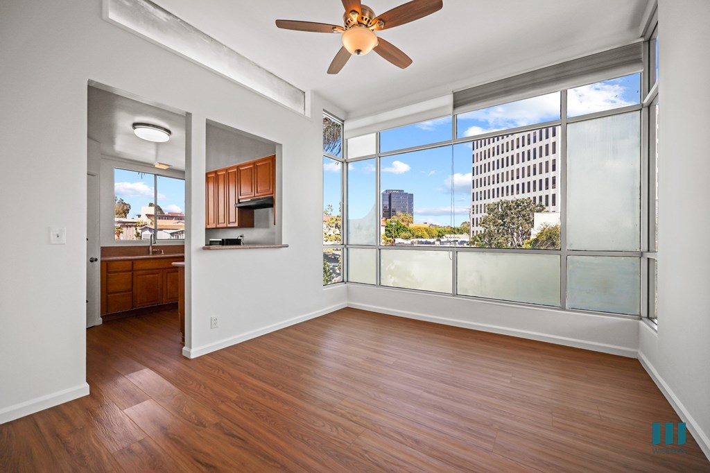 Kitchen and Dining Area with Large-Size Windows and Hardwood Flooring