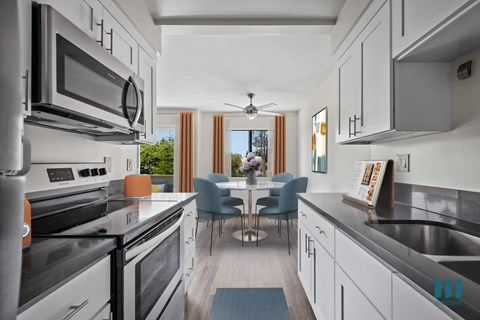 A modern kitchen with a dining table and chairs.