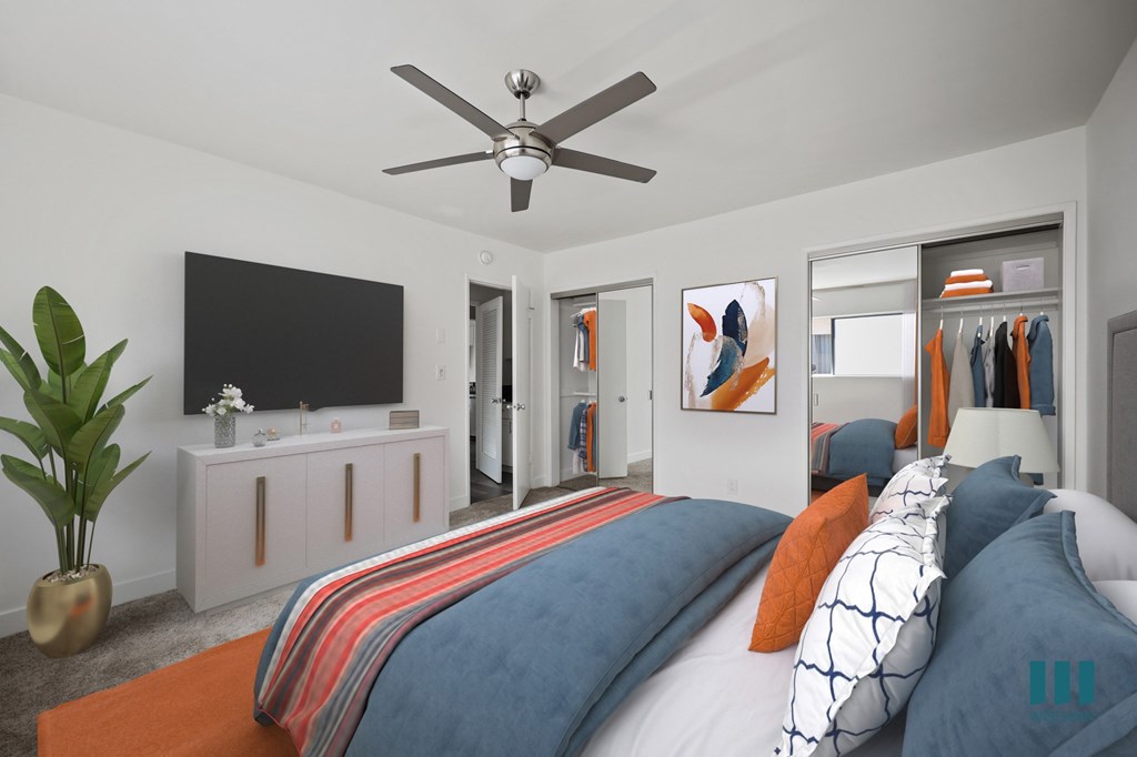 Bedroom with Two-Mirrored Closets, Ceiling Fan, and Carpet