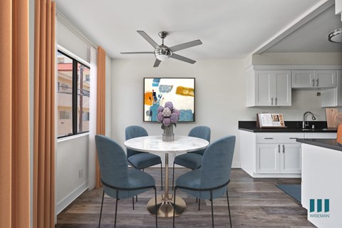 A dining room with a table and chairs.