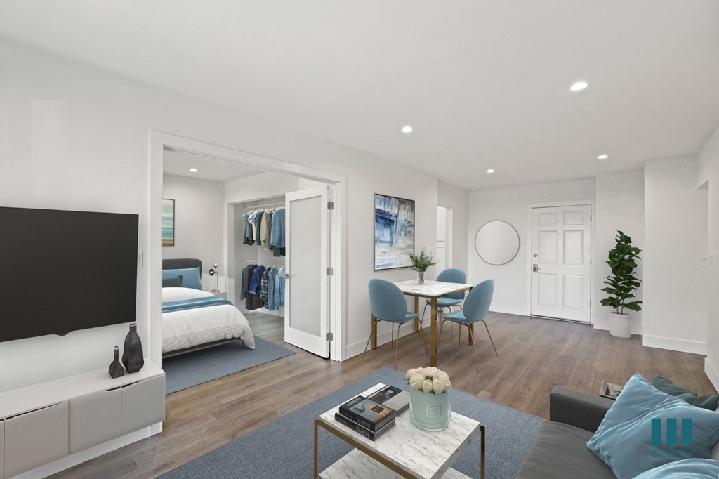 Open-Concept Dining and Living Room with Double Doors Leading to Bedroom with Closet