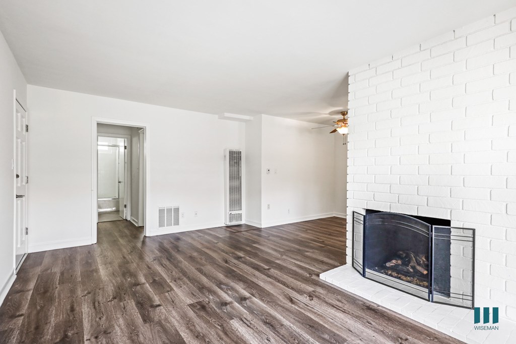 Open-Concept Living Room with a Fireplace and Vinyl Flooring