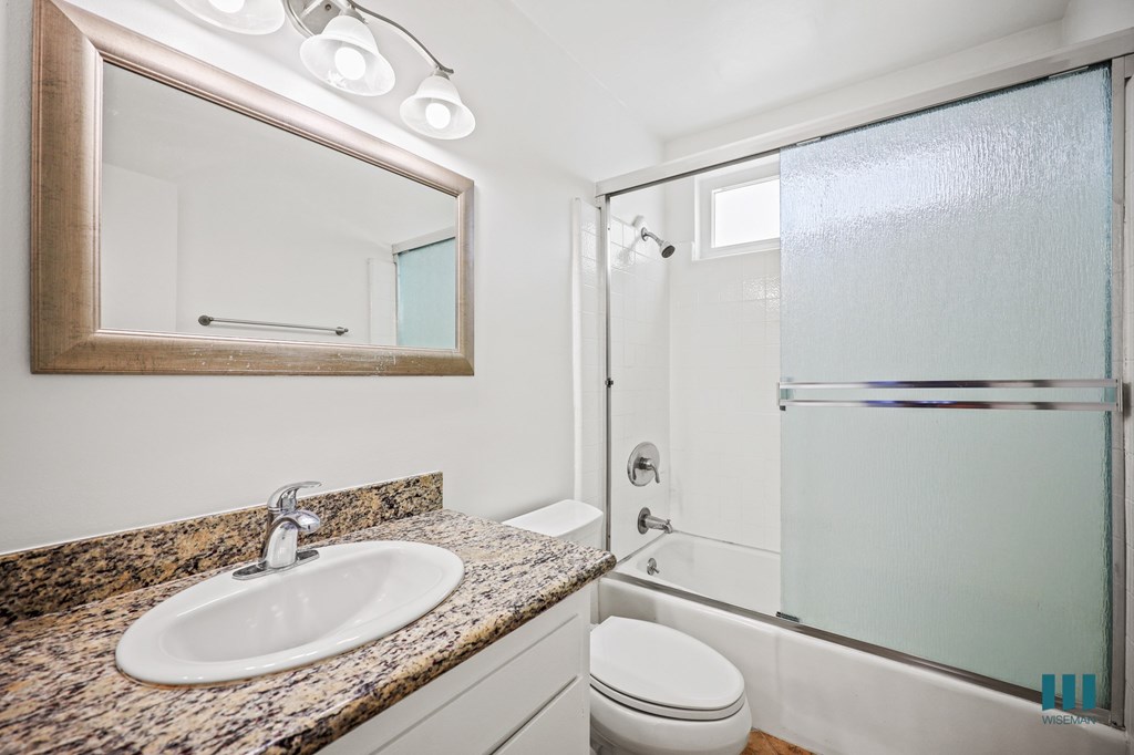 Bathroom with Shower Bath with Glass Door and Vanity Cabinet Storage
