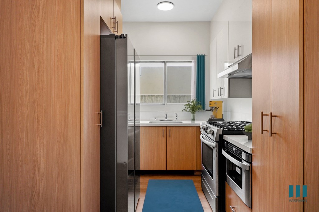 a kitchen with wooden cabinets and a stove and a refrigerator