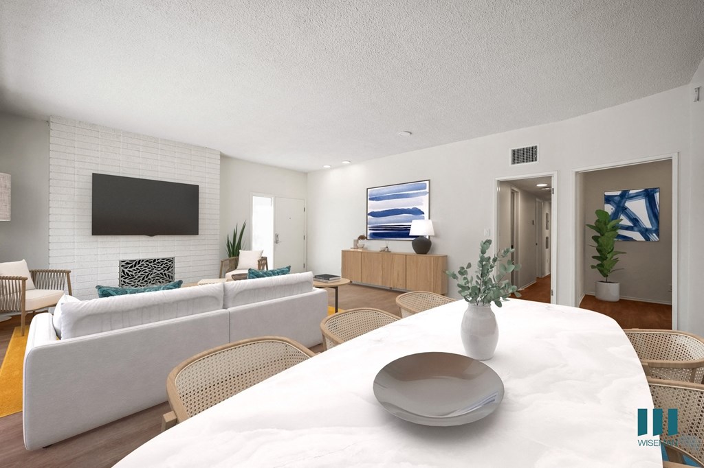 a living room and dining room with a white table and chairs